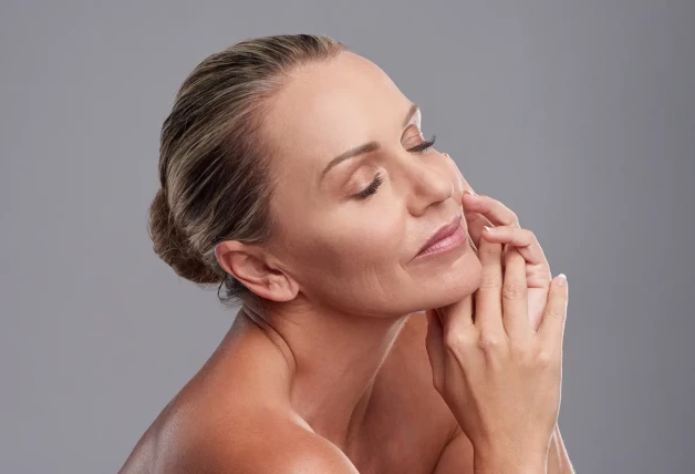 Mujer madura posando con maquillaje en la cara.