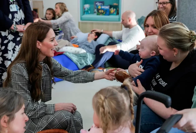 Kate Middleton saludando a un bebe en un hospital