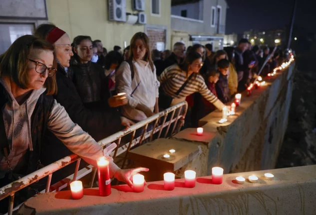 Asistentes portan velas en el homenaje en el barranco del Poyo a los fallecidos por la dana que arrasó parte de la zona, cuando se cumple un mes de la catástrofe. EFE