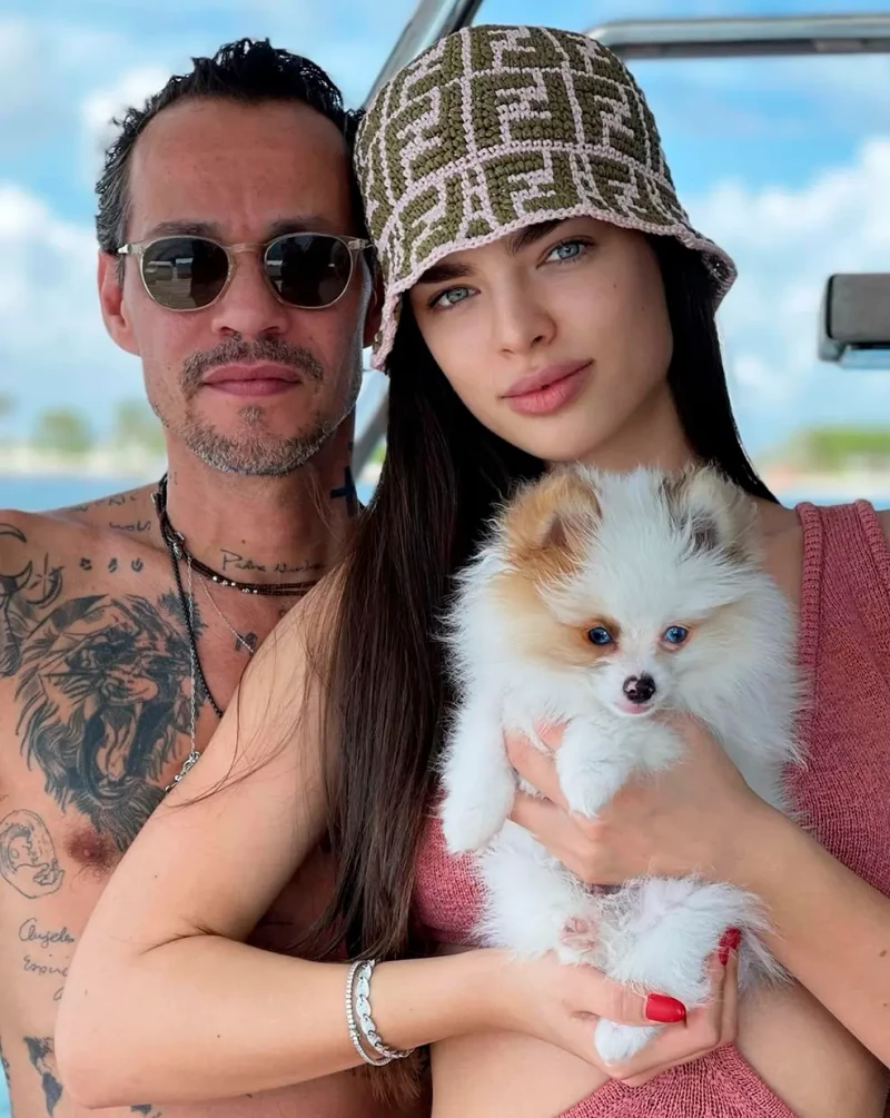 Marc Anthony y su mujer, Nadia Ferreira, con un perro en brazos.