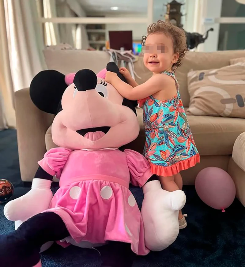 Ana Sandra jugando con un peluche de la Minnie en el salón