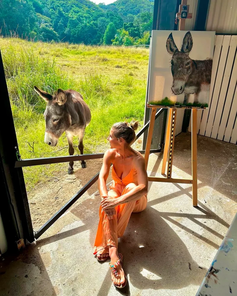 Elsa Pataky junto a un burro y un cuadro retrato del mismo.